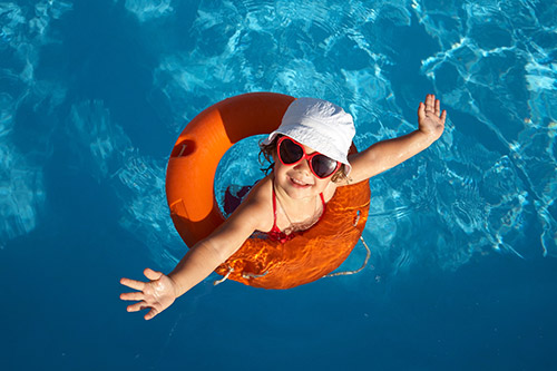 Young girl in sunglasses in pool