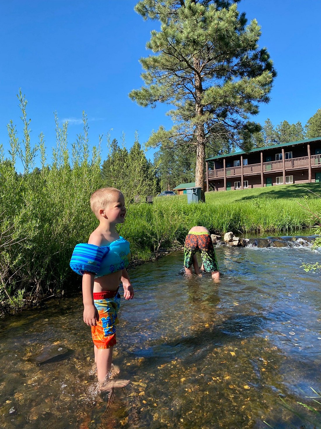 Kids standing in the creek